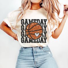 a woman wearing a t - shirt that says gameday on it with a basketball in the center