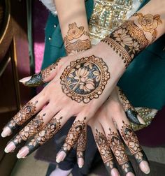 two hands with henna tattoos on them