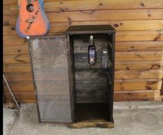 an old metal cabinet is next to a guitar