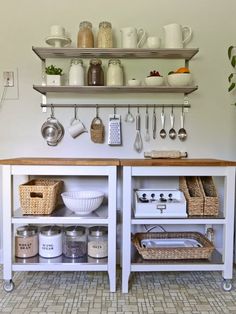 a kitchen area with shelves, pots and pans