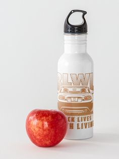 an apple and water bottle sitting next to each other