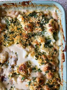 a casserole dish with chicken, broccoli and gravy on top