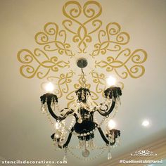 a chandelier hanging from the ceiling in a room with white walls and ceilings