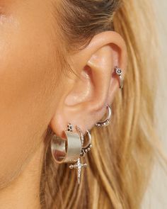 a close up of a person wearing some kind of earring with stars on it