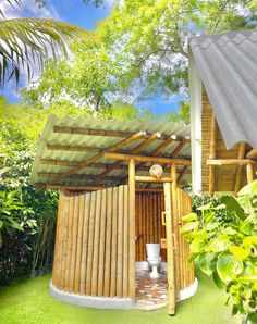 an outdoor toilet in the middle of a lush green area with trees and bushes around it