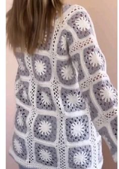 a woman is wearing a white crocheted sweater with flowers on the front and back