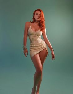 a woman with red hair in a tan dress