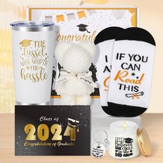 the graduation gift box includes a teddy bear, candle, socks and coffee mugs