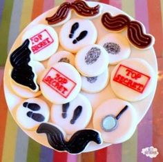 a white plate topped with lots of different types of buttons and mustaches on top of it