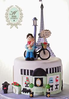 there is a cake that looks like the eiffel tower with a man on it