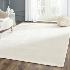 a large white rug in a living room