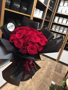 a large bouquet of red roses in a store