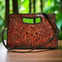 This rustic hand-tooled leather purse, featuring a stunning chiseled artisan design, adds a touch of vintage elegance to your daily ensemble. Ideal for carrying all your essentials, this purse is handcrafted with love and care by skilled artisans, offering a unique rustic charm rarely found in stores.  With exquisite chiseling on both sides, it makes the perfect gift for her on special occasions.  Measures: 🌹height: 20cm. 8  inch 🌹width : 29 cm.  11.4inch 🌹base:4 cm.    1.5 inch Large  adjust Rectangular Engraved Shoulder Bag, Brown Engraved Bags For Everyday Use, Engraved Brown Bags For Everyday Use, Artisan Engraved Rectangular Bag, Artisan Rectangular Engraved Bag, Artisan Rectangular Engraved Bags, Artisan Engraved Shoulder Bag For Everyday, Artisan Shoulder Bag With Engraving For Everyday Use, Artisan Shoulder Bag With Engraved Details For Everyday Use