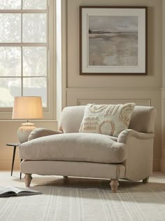 a living room scene with focus on the arm chair and lamp in the foreground