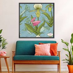 a blue couch sitting in front of a painting on the wall next to potted plants