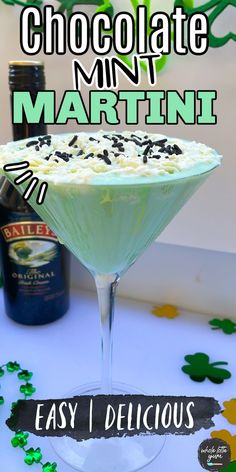 chocolate mint martini in a martini glass with sprinkles on the table and shamrock decorations around it