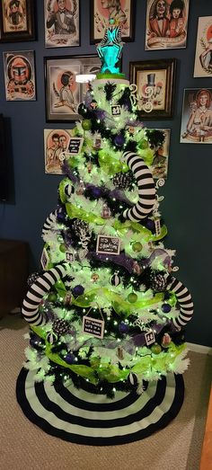 a green christmas tree with black and white decorations