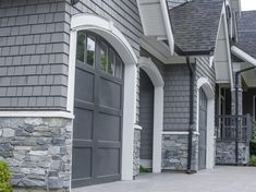 a gray house with two large garage doors