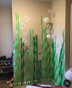 the room is decorated with balloons and streamers for an under the sea theme on the wall