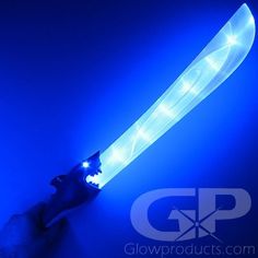 a person is holding a glowing object in their hand with blue light coming from it