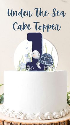 a white cake topped with a blue number one and sea animals