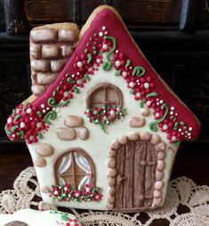 a gingerbread house decorated with icing and decorations