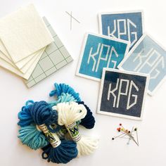 several pieces of crafting material including yarn, scissors and stickers on a white surface