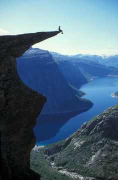 a person standing on the edge of a cliff with a quote above it that says, let