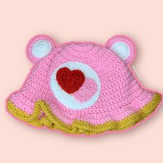 a crocheted bear hat with a heart on it