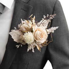 a man in a suit with a boutonniere and flowers on his lapel