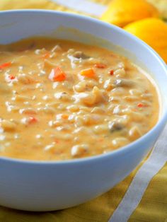 a white bowl filled with soup sitting on top of a yellow and white table cloth