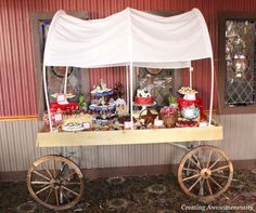 a wagon with some food on it in front of a red and white wall,