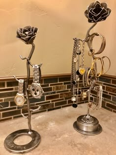 two metal sculptures with rings and flowers on them in the middle of a kitchen counter