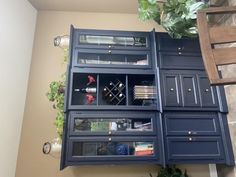 a blue cabinet with many drawers and shelves