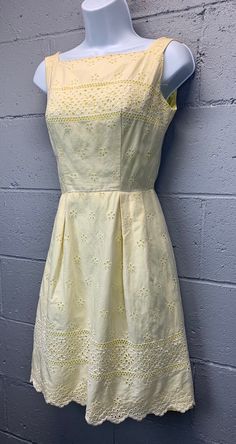 Vintage 1950s pale yellow eyelet lace sundress. Apron style bodice with a fitted waist. Hemline sits just above or at the knee.  Zips up the back with a metal zipper.  Fully lined in yellow cotton/polycotton.  Excellent vintage condition. No noted flaws. Shows a little age appropriate wear.  Tagged size 7 fits most like a modern small.  Please use measurements provided to decide if the fit works for you.  Dress is laid flat and measured.  Bust (armpit to armpit) - 16 inches  Waist - 12 inches  H Affordable Vintage Yellow Dress, Affordable Yellow Vintage Dress, Cheap Yellow Vintage Dress, Cheap Yellow Vintage Dresses, Summer Dresses Miggon 🛍️, Elegant Vintage Dresses Miggon 🛍️, Vintage Dresses Miggon 🛍️, Pale Yellow Dress, Pale Yellow Dresses