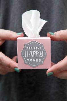 two hands holding a tissue box that says for your happy tears