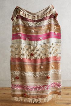 an old blanket with fringes and flowers on it