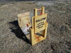 a wooden sign that says gullotne little critte trap in the grass