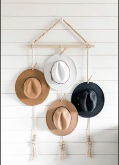 three hats are hanging on the wall