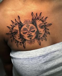 a woman's chest with sun and moon tattoos on it