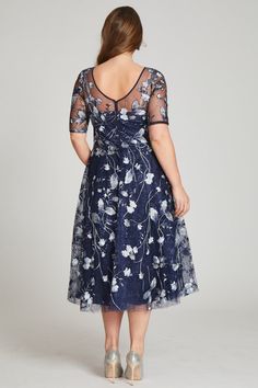 Perfect for cocktail attire events or black tie wedding, this tulle tea length navy and multicolored floral embroidered dress is both flattering and fun. The sheer illusion neckline elongates the torso and the a-line skirt narrows the waist. The light airy fabric makes dancing the night away a breeze. Tea length Elbow length sleeves Illusion neckline Pair with diamond or sapphire jewelry Fit: True to size Length: Knee to Tea length Undergarments: May be worn with any standard bra Black Tie Wedding Guest Dress Spring, Tulle Cocktail Dress, Tea Length Bridesmaid Dresses, Plus Size Gowns, Floral Cocktail Dress, Cocktail Attire, Floral Embroidered Dress, Embroidered Tulle, Illusion Neckline