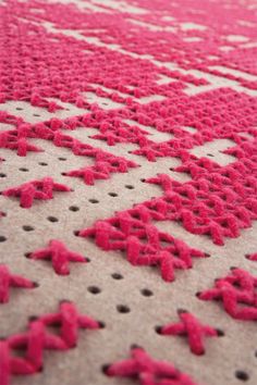 a close up view of a rug with red and white designs on the carpeting