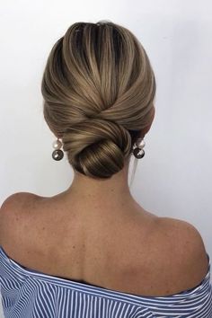 a woman with blonde hair in a low bun