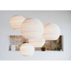 four white paper lanterns hanging from the ceiling