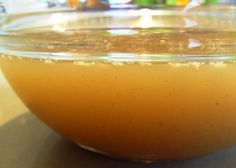 a glass bowl filled with liquid sitting on top of a table