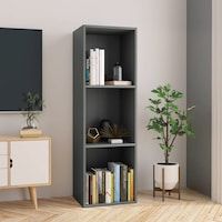 a living room with a tv and bookcase in the corner next to a potted plant