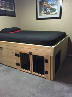 a dog house made out of pallets in the corner of a room with pictures on the wall