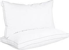 a white pillow sitting on top of a bed