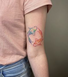 a woman with a tattoo on her arm that has a koi fish in it