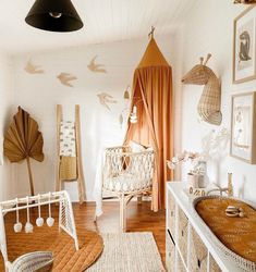 a baby's room with white walls and wooden floors